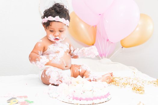 Young Baby Girl Celebrating Her First Birthday With Cake