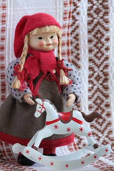 little puppets in national traditional  folklore dress Finland standing beside rocking horse