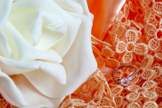  wedding rings on  a colorful fabric background