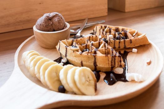 Belgian waffles with strawberry, cherry, blueberry, and chocolate sauce