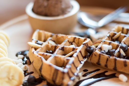 Belgian waffles with strawberry, cherry, blueberry, and chocolate sauce.