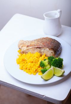 Healthy fish dinner with saffron rice and vegetables