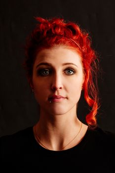 Portrait of a beautiful redhead woman staring into the camera.