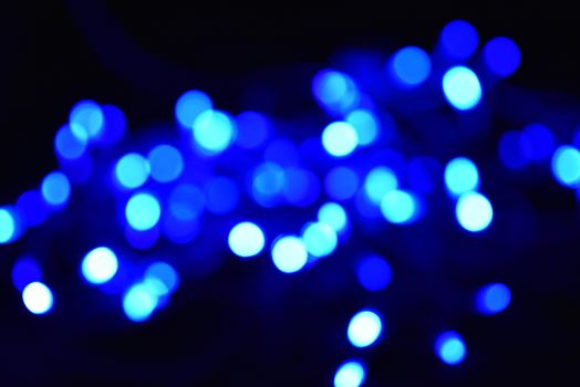 Blue and white blurred bokeh lights background.