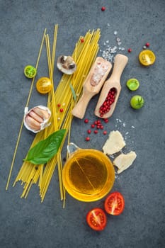 Italian food concept. Spaghetti with ingredients sweet basil ,tomato ,garlic peppercorn ,champignon,zucchini and parmesan cheese on dark background flat lay and copy space.