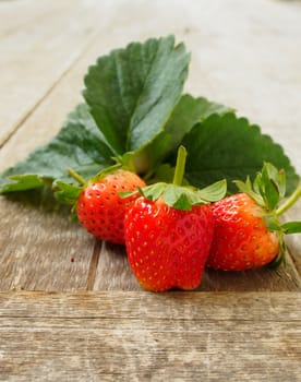 Strawberries from the garden's collection, put on a wooden table.