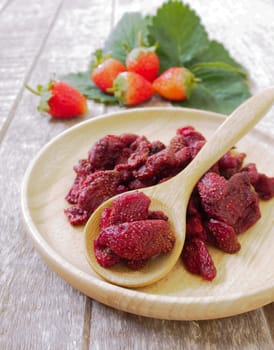 Strawberries, berries, dried in a wooden spoon.