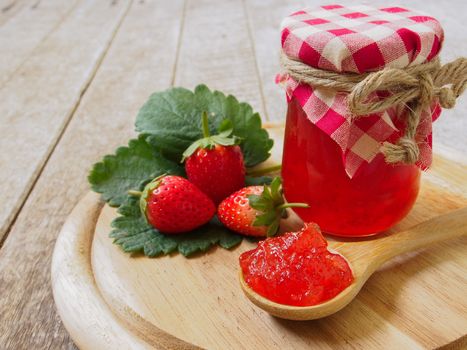 strawberry jam  in a wooden spoon