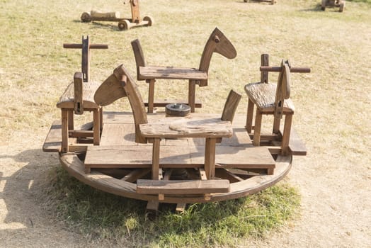 Wooden toys, children's carousel in the park in the country.