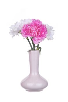 Flowers pink and white carnations in a vase isolated on white background.