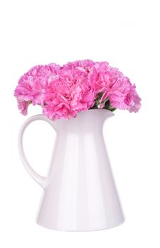 Pink carnations in a vase isolated on white background.