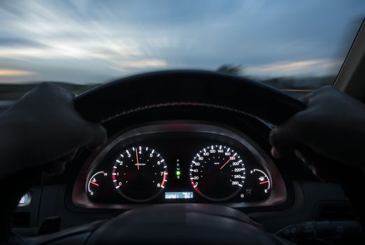 Speed driving at 180 km/h on the road at sunset.