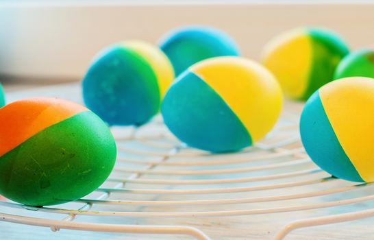 Easter eggs painted by hand yellow and blue lie on lattice