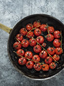 close up of rustic roasted red summer cherry tomato 