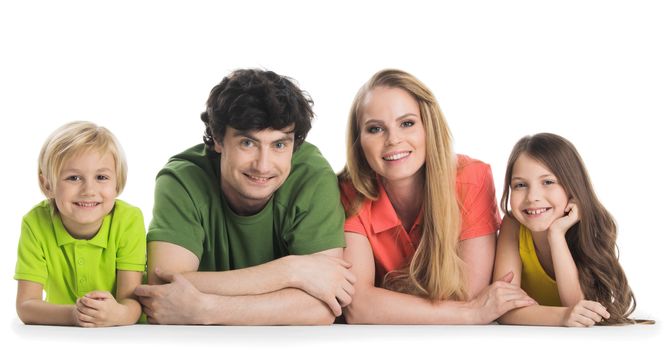 Casual family in colorful clothes lying on the floor isolated on white background