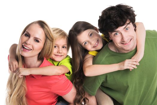 Studio portrait of family in colorful clothes with two children isolated on white background