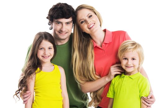 Studio portrait of family in colorful clothes with two children isolated on white background