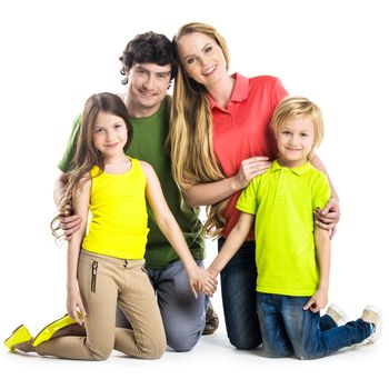 Studio portrait of family in colorful clothes with two children isolated on white background