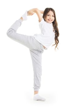 Small girl doing stretching leg exercise isolated on white background