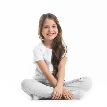 Portrait of small girl sitting turkish isolated on white background