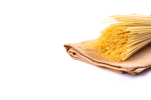 uncooked pasta on a cloth on a white background