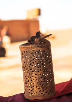 wrought iron berber lamp with traditional nomad tents on background