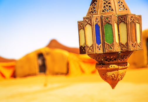 coloreful berber lamp with traditional nomad tents on background