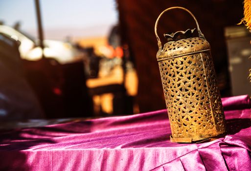 wrought iron berber lamp with traditional nomad tents on background