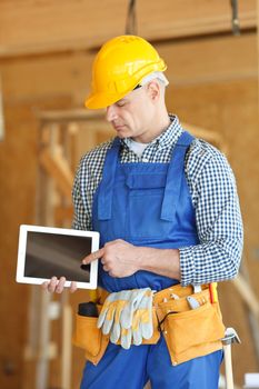 Construction worker pointing at digital tablet close-up