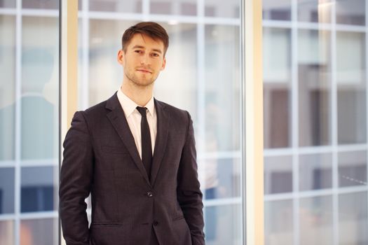 Portrait of a young handsome businessman indoors