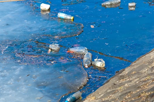 Waste, trash and garbage floated on a polluted river