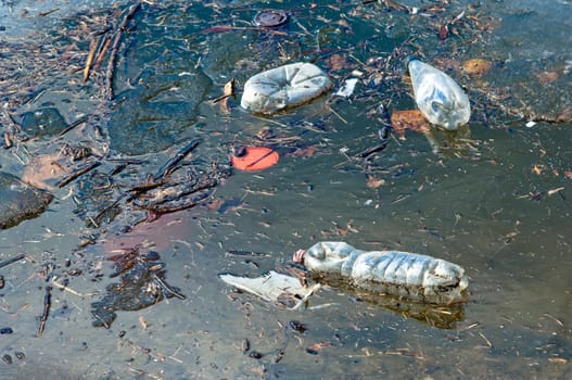 Waste, trash and garbage floated on a polluted river