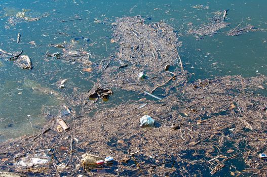 Waste, trash and garbage floated on a polluted river