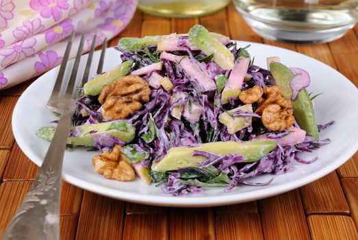 salad  red coleslaw with slices of avocado, apple, nuts, parsley, dill seasoned yoghurt sauce
