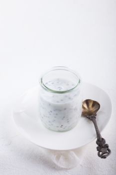 Yogurt pudding with chia seeds on a white plate