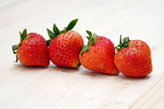 Row Red Strawberry Group on the Table Wood