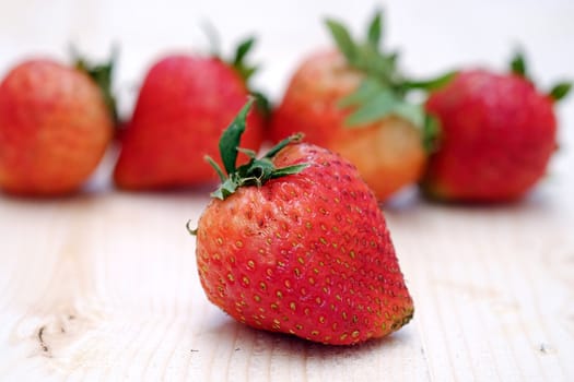 Red Strawberry Group on the Table Wood