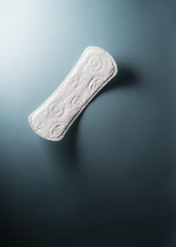 close up view of woman's sanitary pad on color back