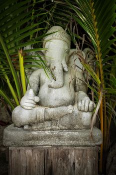 Old concrete  statue of Ganesha - a hindu symbol of luck in the jungle
