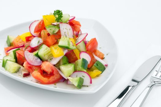 close up view of fresh vegetable salad on white background