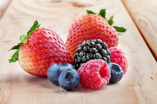 close up view of nice fresh berries on wooden background