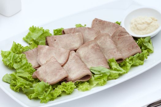 Close up view of cold boiled sliced meat on white back