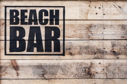 close up view of beach bar logo stamped on wooden surface