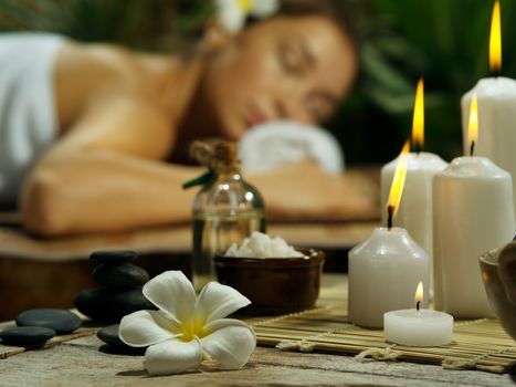 portrait of young beautiful woman in spa environment.  focused on candles