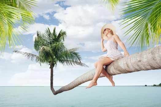 view of nice young lady sitting on palm  on tropical beach.