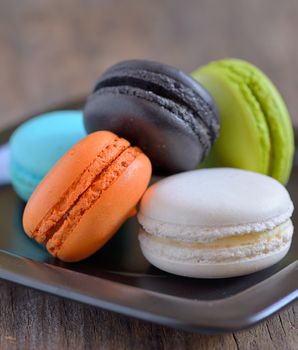 french colorful macarons on wooden table