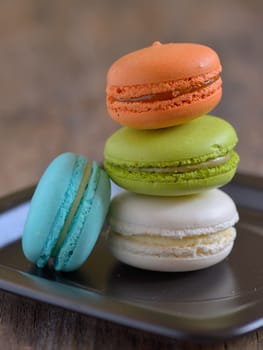 french colorful macarons on wooden table