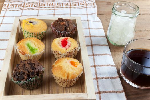 Cupcake various flavors in wood tray on wood table. coffee break