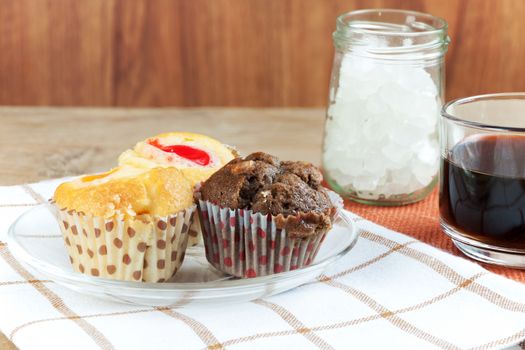 Cupcake various flavors in wood tray on wood table. coffee break