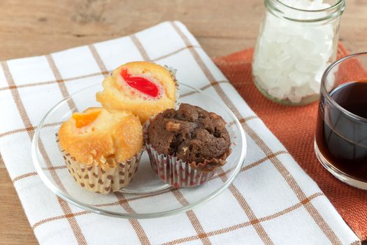 Cupcake various flavors in wood tray on wood table. coffee break